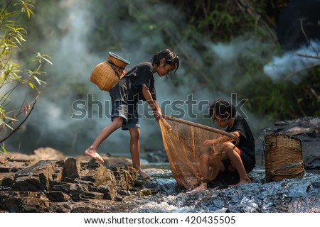 Children poverty living in countryside Vietnam are fishing at the river. Royalty-Free Stock Photo #420435505