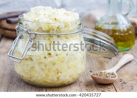 Homemade sauerkraut with cumin in a glass jar  Royalty-Free Stock Photo #420435727