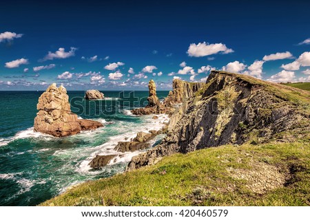 Dramatic view of 
Playa de la Arnia, rocky coastline in Santander, Cantabria, Spain. Royalty-Free Stock Photo #420460579