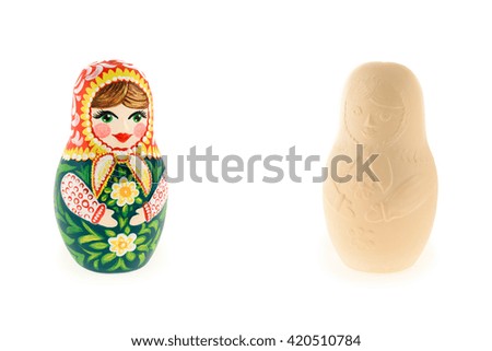 Two traditional matreshka doll made of clay both painted and unpainted
