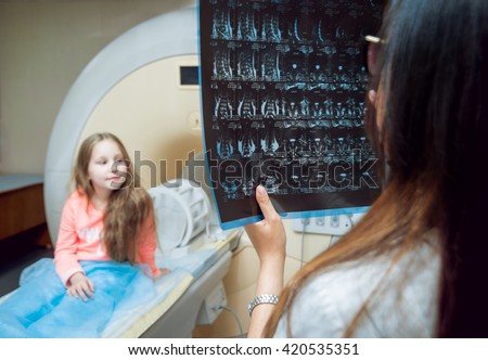 Medical equipment. Doctor looking MRI picture