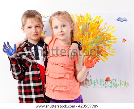 girl and boy with hands painted drawing.