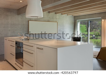 Interior of a modern chalet in cement, hob of kitchen