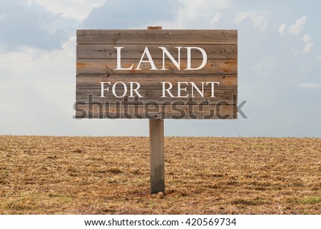 Land for rent - wood board with text on soil background