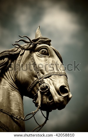 A horse head statue isolated over a blue sky