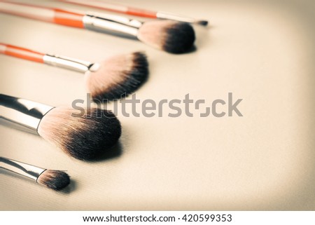 Collection of professional makeup brush on textured background