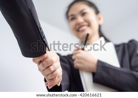 Women business people shaking hands on  white background