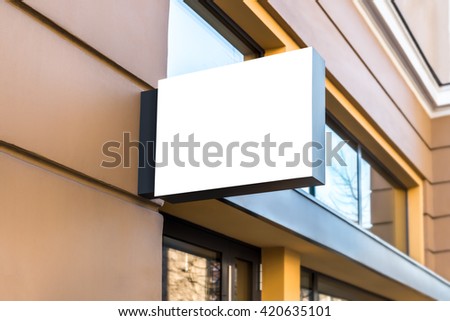 Blank mock up design of cafe signboard on a yellow wall