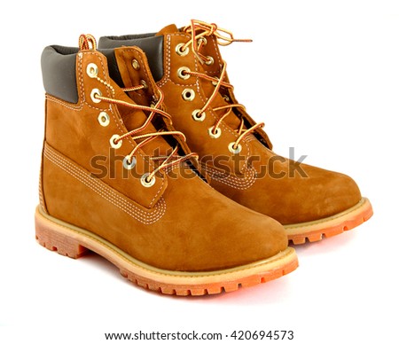 Brown lady's boots with shoelace on white background. Royalty-Free Stock Photo #420694573
