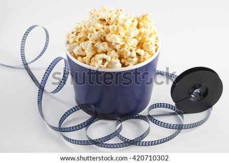 Cinema concept of vintage film reel with popcorn