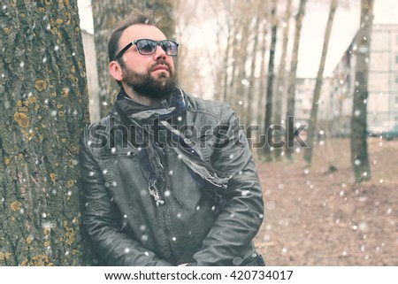 winter beard man in park with headphone