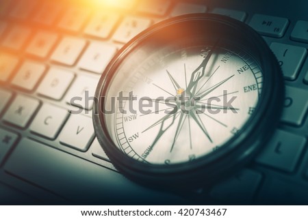The Internet Navigator Concept Photo. Vintage Metallic Compass on the Computer Keyboard. Navigation Through the Internet. Royalty-Free Stock Photo #420743467
