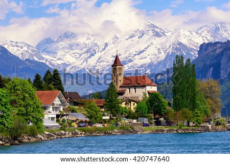 Brienz town on Lake Brienz by Interlaken, Switzerland, with snow covered Alps mountains in background Royalty-Free Stock Photo #420747640