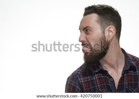 Why too serious? Shot of a bearded man looking at the copyspace sticking his tongue out at the studio isolated on white.