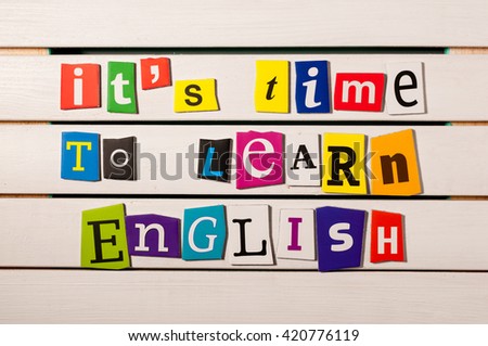 learning english concept. it's time to learn English - written with color magazine letter clippings on wooden board