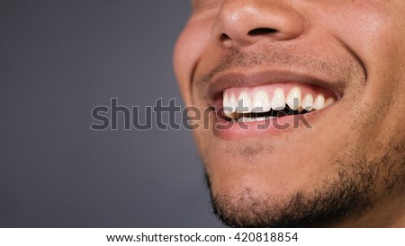 Healthy teeth of a male as he smiles at something, space for text Royalty-Free Stock Photo #420818854