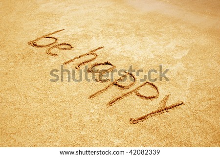 Be happy handwritten in sand for natural, symbol,tourism or conceptual designs