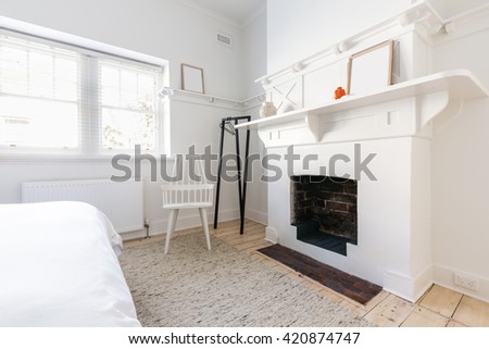 Feature open fireplace in a luxury renovated Danish styled bedroom