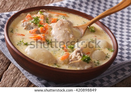 Belgian cuisine: cream soup with chicken close up in a bowl on the table. horizontal

