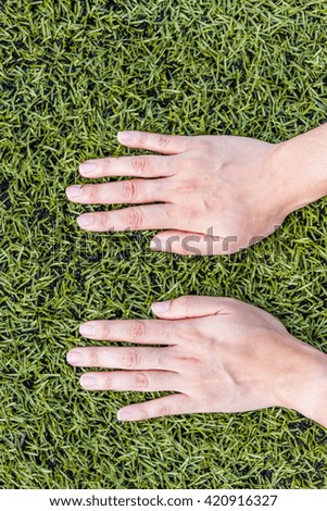 girl hand on soccer field grass background
