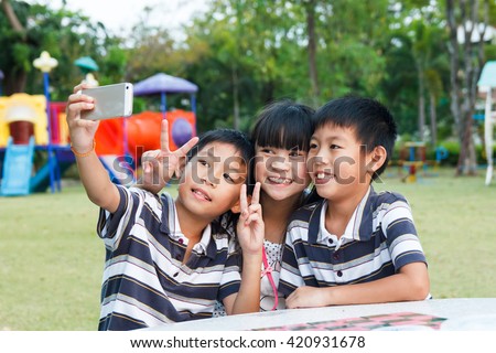 Thai twin brother and sister selfie at playground.