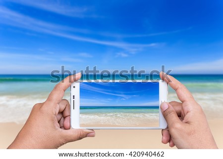 Close up hand of woman holding smartphone and take photo of view