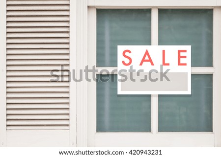 Sale Real Estate Sign in Front of house

