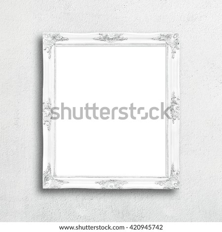 Classic white blank picture frame on white wall.