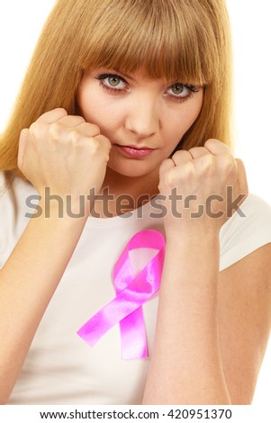 Woman wih pink ribbon on chest punching boxing. Fight against disease. Healthcare, medicine and breast cancer awareness concept