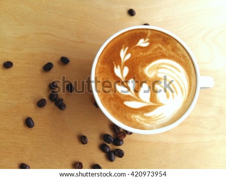 Latte art coffee so delicious on wood background