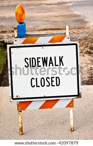 a road sign "sidewalk closed" in front of a road work. the text can easily be erased. put your own text there.