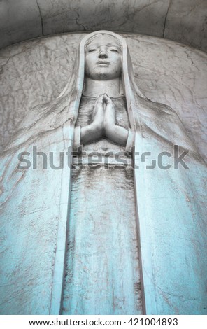 Statue of dying woman on deathbed with turquoise tunic