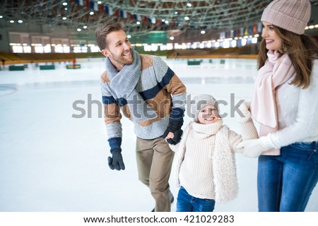 Happy family at skating rink