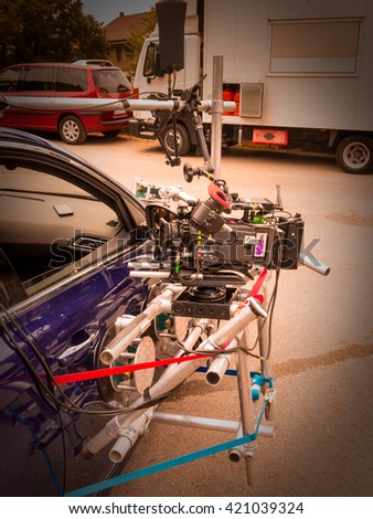 Detail of a film camera, fixed to the door of a vehicle, ready to shoot