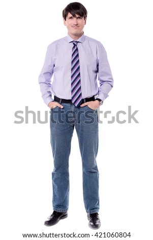 Casual picture of businessman, standing with hands in pockets.