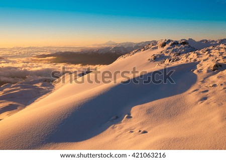 Beautiful amazing sunset.  Mountains in north country Russia Caucasus. Winter sunny landscape.  