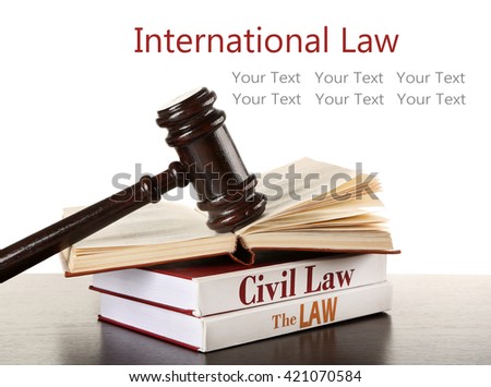 Gavel and books on wooden table on white background. International law concept