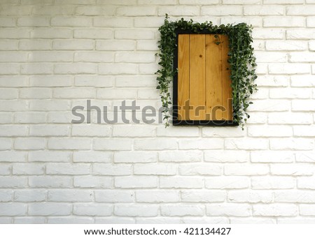 Wooden frame on white wall.