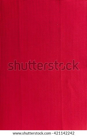Red linen "waffle" tablecloth picnic texture. Textile, napkin, tablecloth. View from above, top. Traditional pattern and color.