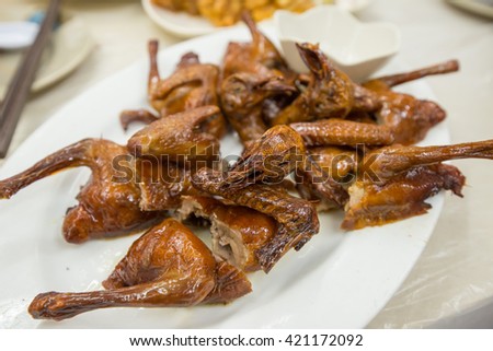 Chinese styled roasted pigeon on plate  