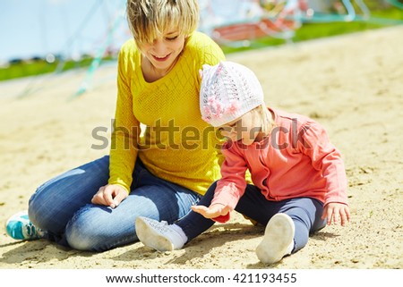 mother and daughter outdoors. child and mom walking in the summer