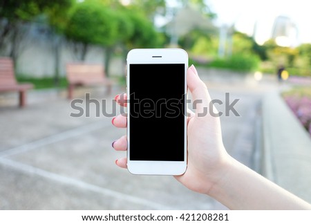 Holding smartphone with black screen.