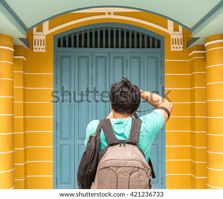 tourism take a picture of beautiful wood door and yellow building