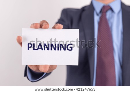 Man showing paper with PLANNING text