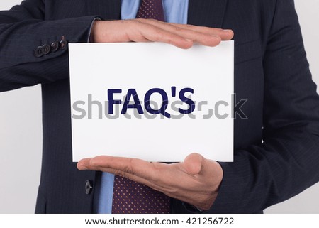 Man showing paper with FAQ'S text