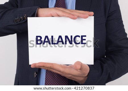 Man showing paper with BALANCE text