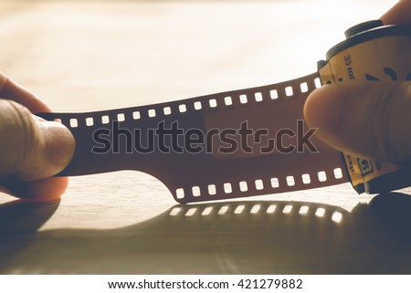 man holding a photo film cartridge  - vintage style