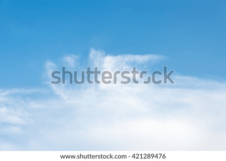 Fluffy clouds in the blue sky.