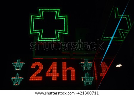 Bright night pharmacy sign on. With the message open 24 hours a day between junctions 