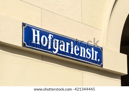 Germany, Bavaria, Munich, Hofgarten: Blue street sign Hofgarten = Court Garden on a wall in the center of the famous Bavarian capital.